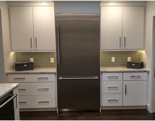 60 Woodcliff Road Brookline, MA 02467 - Photo 9 of 30 a kitchen with a refrigerator and white cabinets
