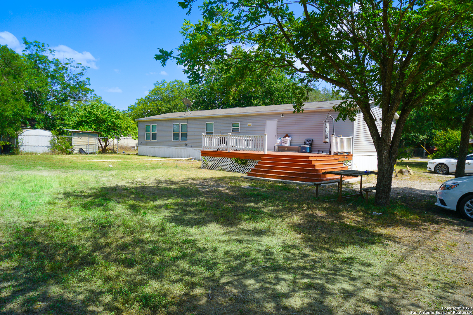 a house view with a sitting space and garden