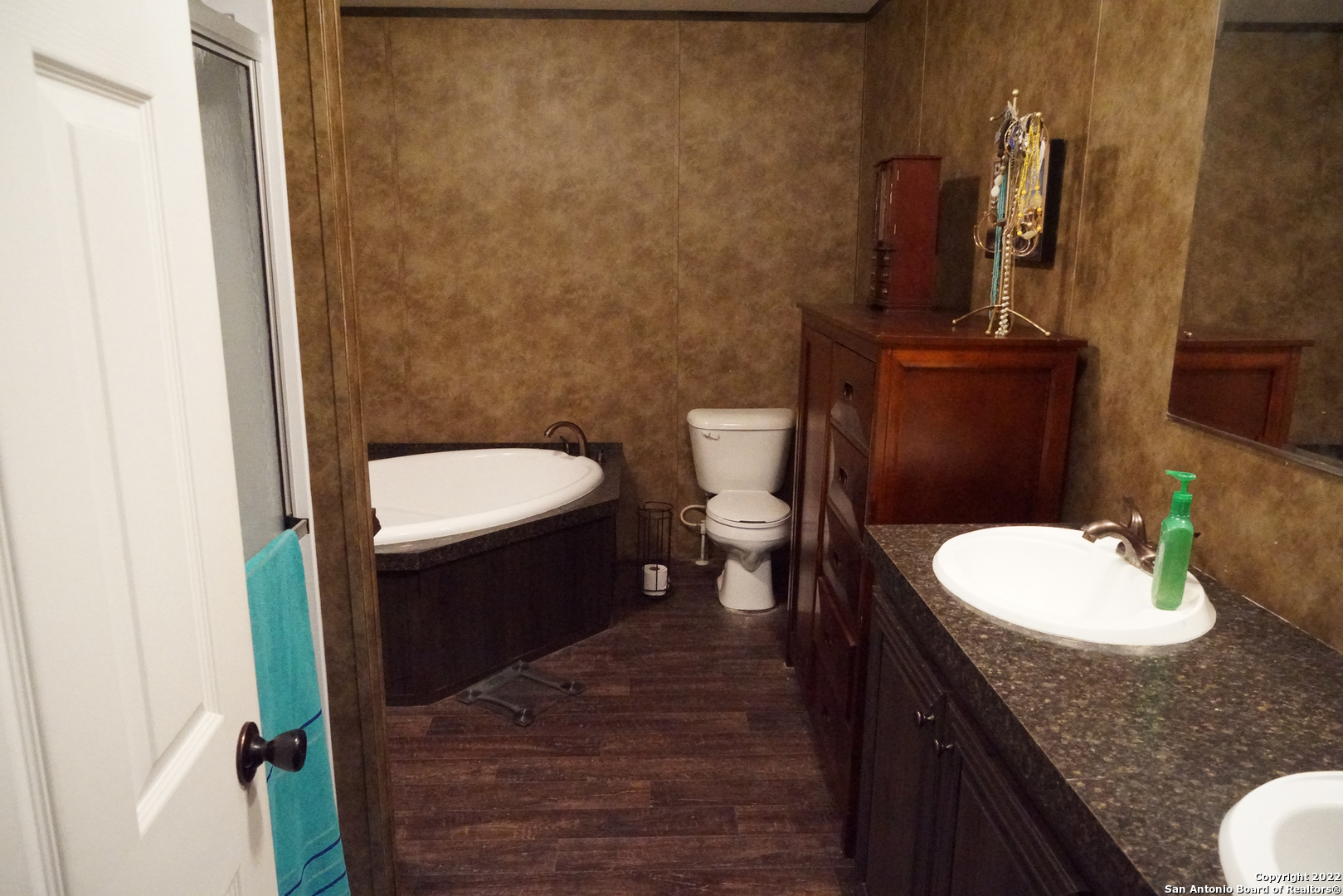 10179 Commerce Street Atascosa, TX 78002 - Photo 12 of 12 a bathroom with a granite countertop toilet and a sink