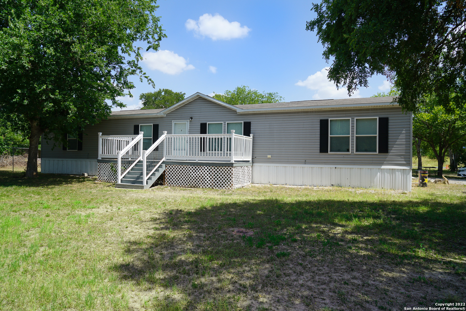 10179 Commerce Street Atascosa, TX 78002 - Photo 2 of 12 a front view of a house with a yard