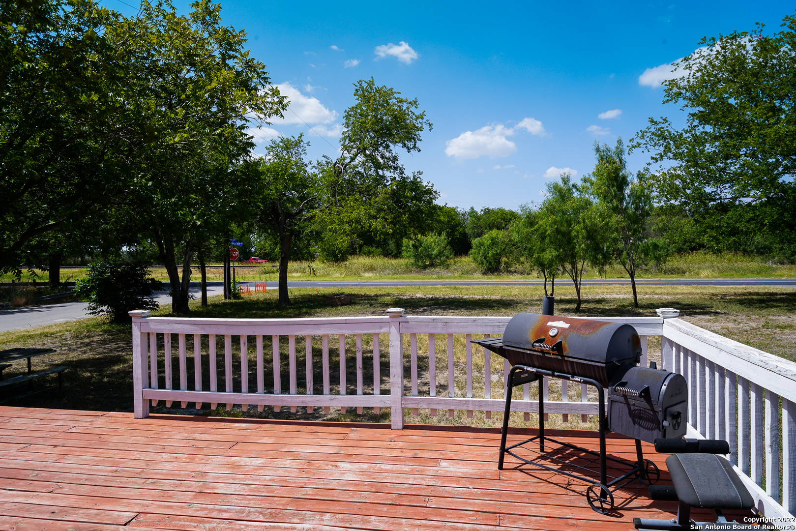 10179 Commerce Street Atascosa, TX 78002 - Photo 3 of 12 a view of deck with seating and trees