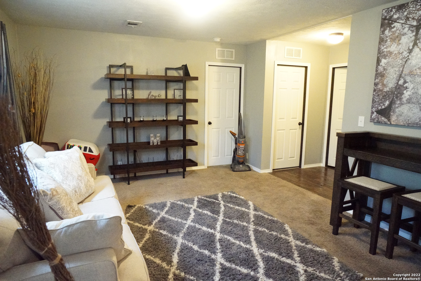 10179 Commerce Street Atascosa, TX 78002 - Photo 4 of 12 a living room with furniture and a book shelf