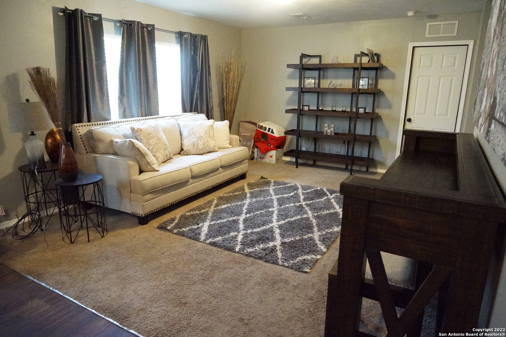10179 Commerce Street Atascosa, TX 78002 - Photo 5 of 12 a living room with furniture a air conditioner vent and a window