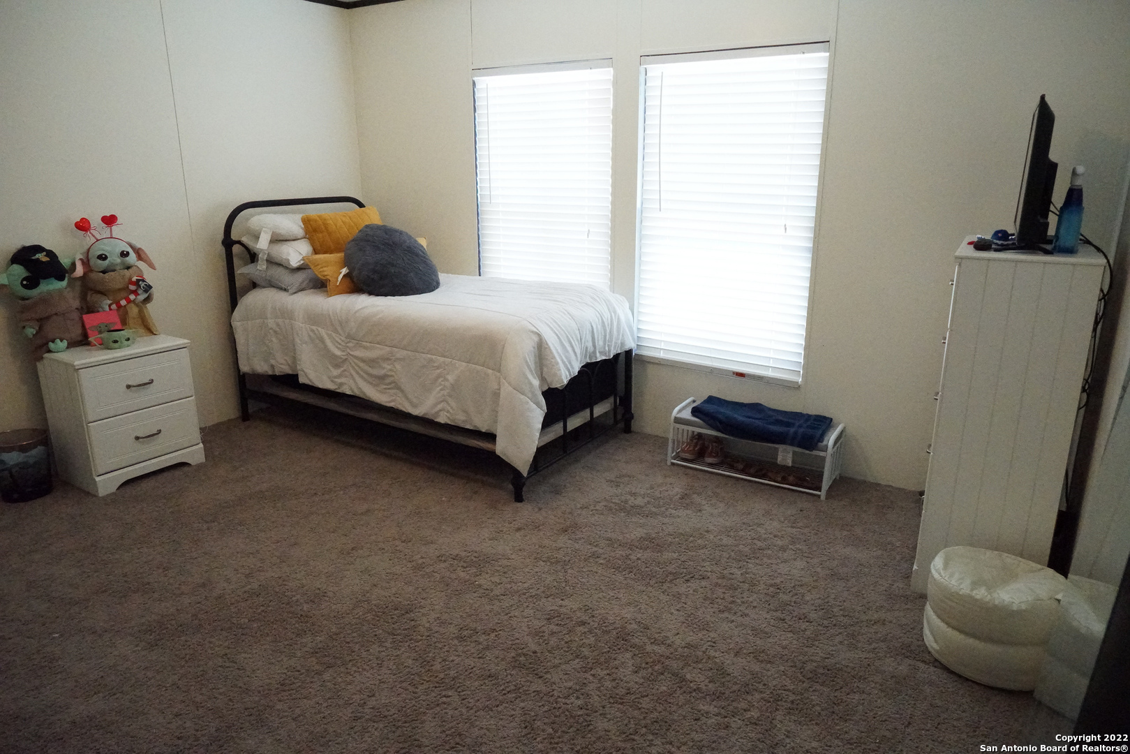 10179 Commerce Street Atascosa, TX 78002 - Photo 8 of 12 a bedroom with a bed and a couch