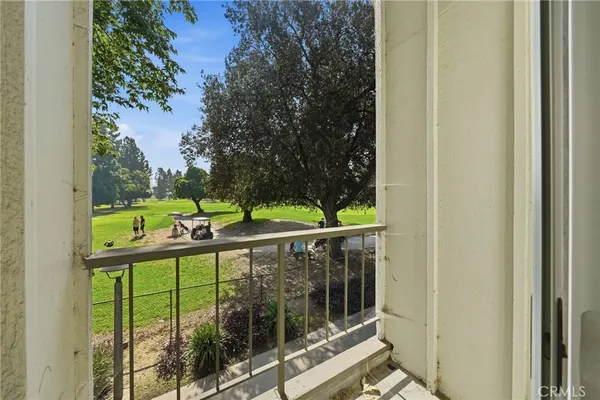a view of balcony with small yard