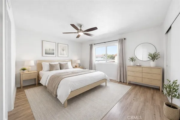 a spacious bedroom with a large bed and a chandelier