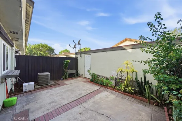 a backyard of a house with table and chairs
