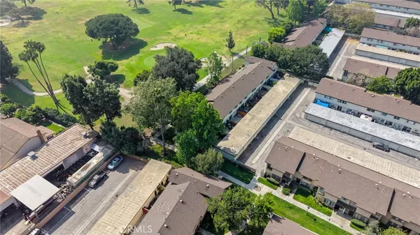 an aerial view of multiple houses with yard