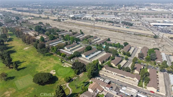 an aerial view of residential houses with outdoor space