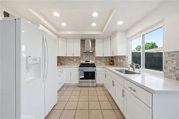 a large kitchen with a sink and cabinets