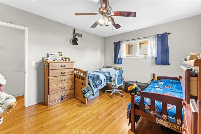 a bedroom with furniture and a wooden floor