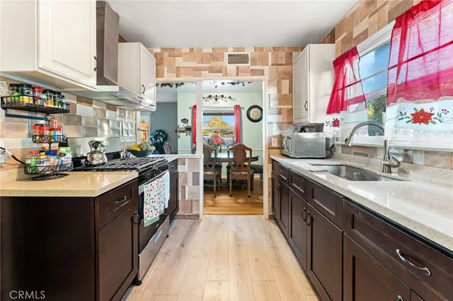 a kitchen with stainless steel appliances granite countertop a sink and a stove