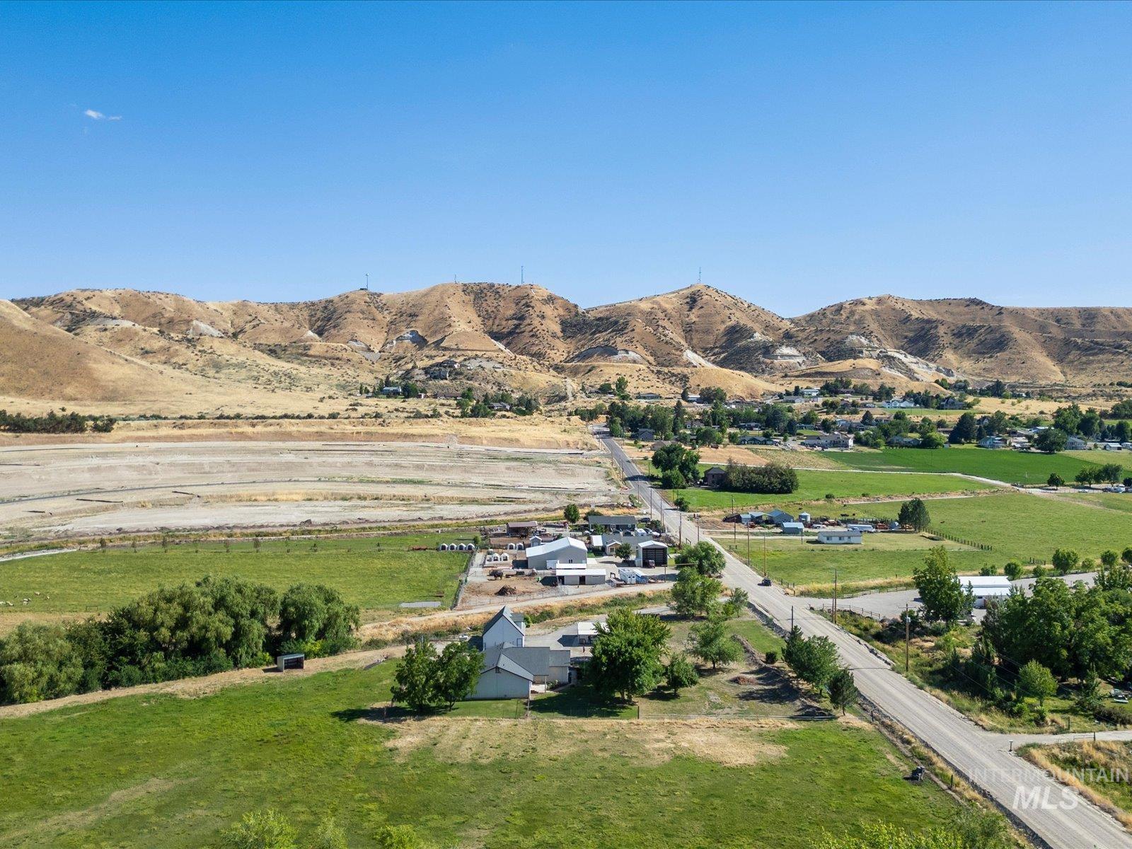 3540 Wills Road Emmett, ID 83617 - Photo 5 of 36 Expansive rural landscape featuring a mix of green fields, mature trees, and a distant mountainous backdrop