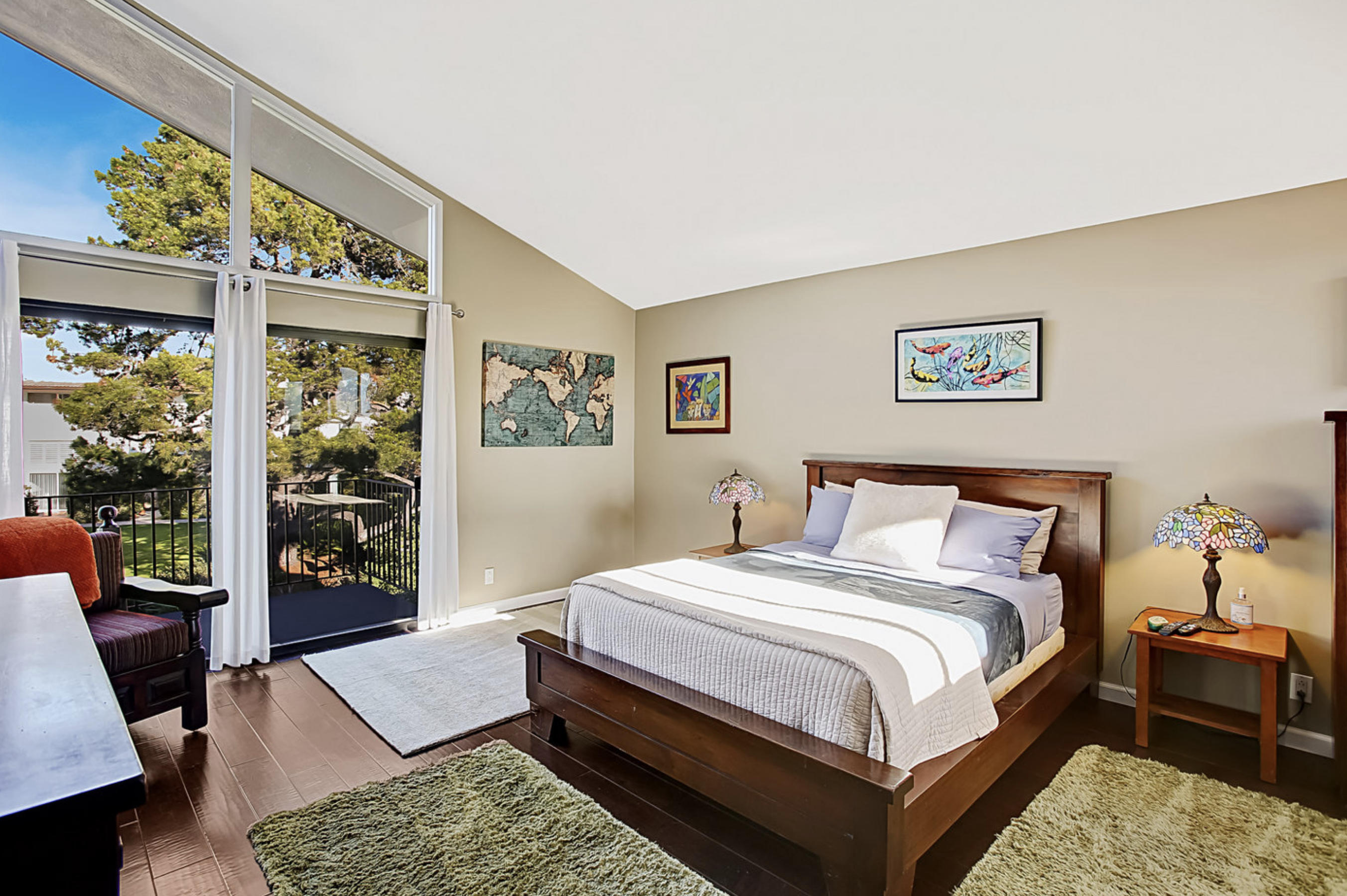 669 Del Parque Drive, Unit D Santa Barbara, CA 93103 - Photo 17 of 37 a bedroom with a bed a dresser and a large window