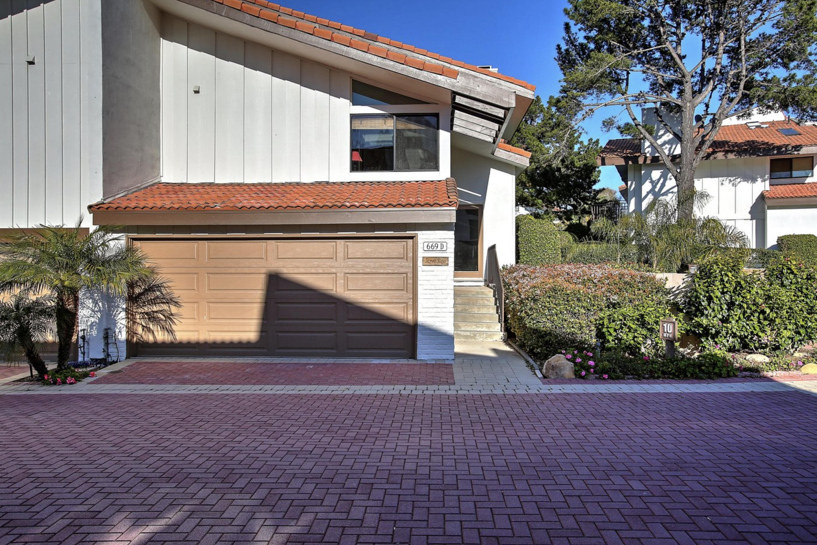 669 Del Parque Drive, Unit D Santa Barbara, CA 93103 - Photo 2 of 37 a front view of a house with a yard and garage