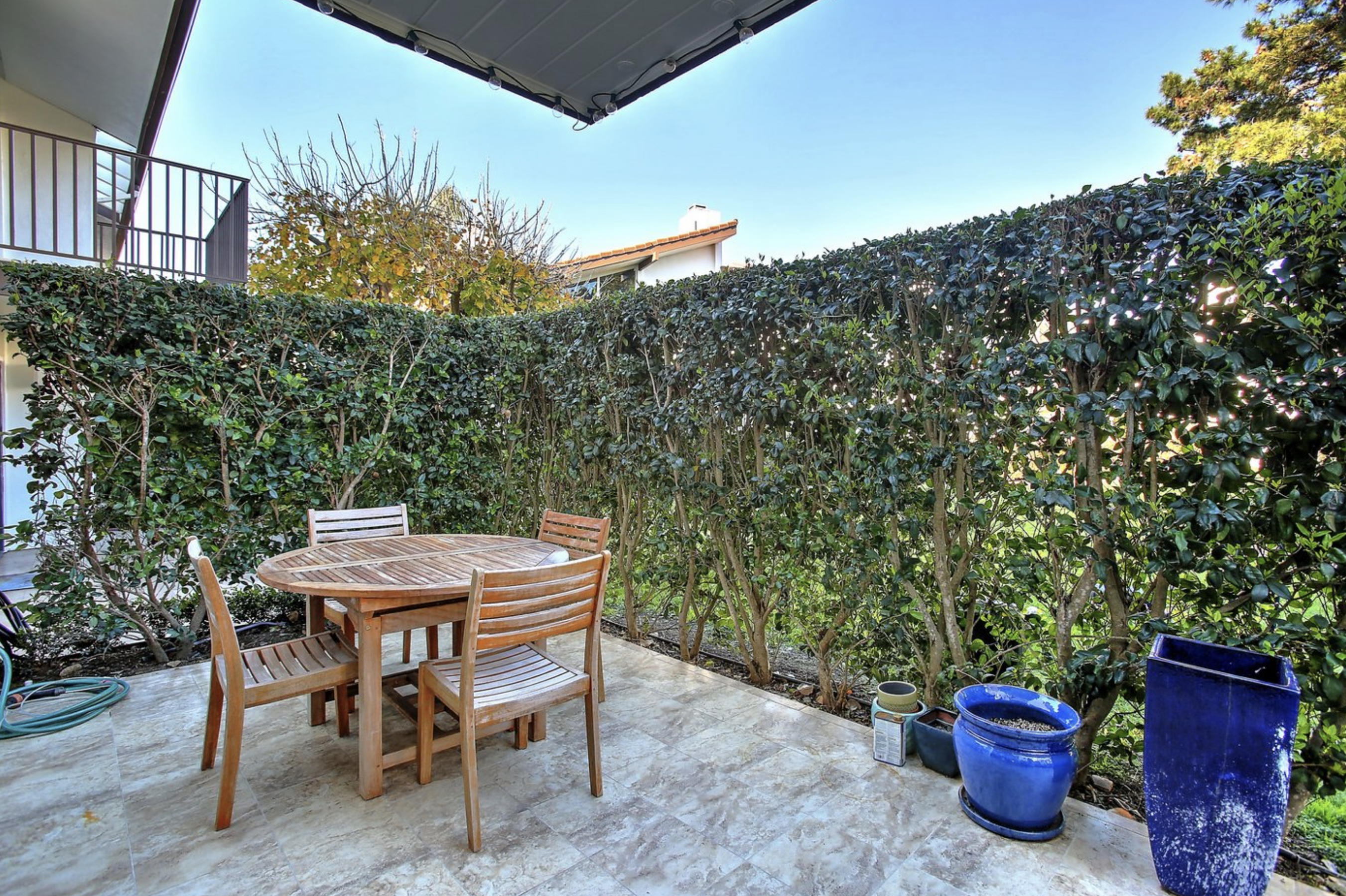 669 Del Parque Drive, Unit D Santa Barbara, CA 93103 - Photo 26 of 37 a view of a backyard with table and chairs potted plants and tree