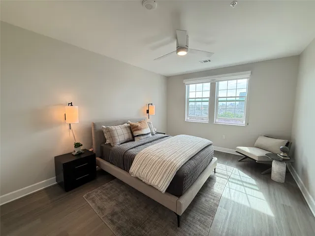 a bedroom with a bed and wooden floor