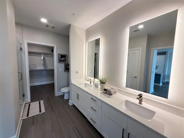 a bathroom with double vanity sinks and a mirror