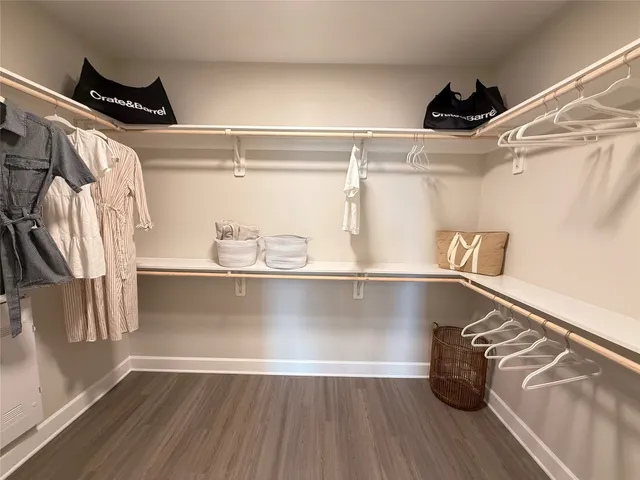 a view of walk in closet with clothes and shoes