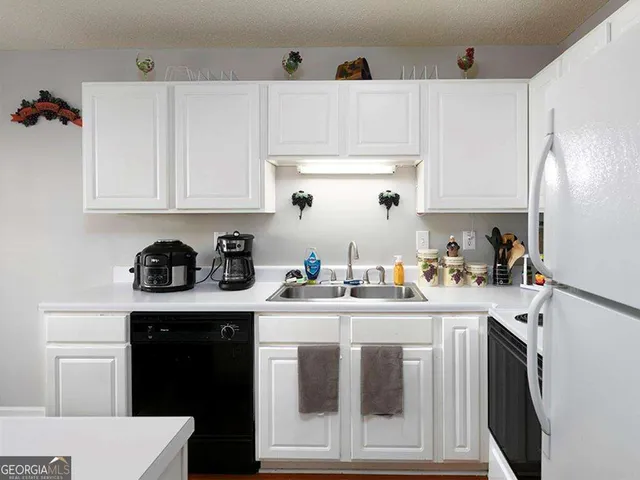 a kitchen with a sink a stove and cabinets