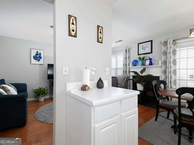 a view of dining room and livingroom with furniture wooden floor and window
