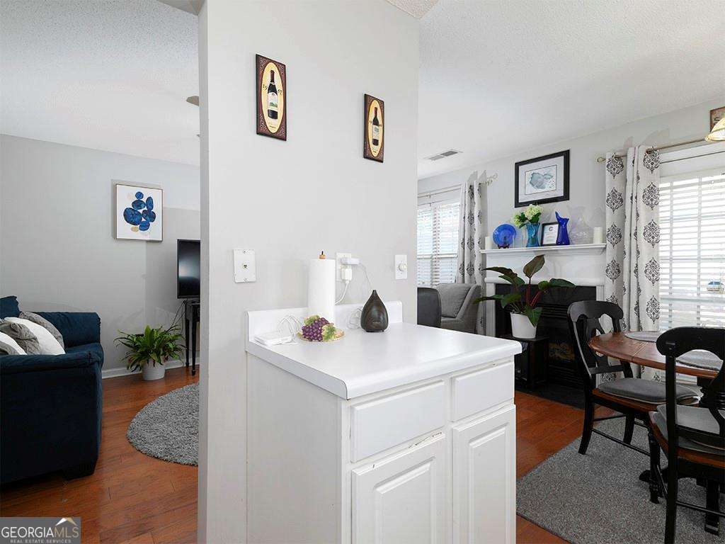 253 Gallant Court Southeast, Unit 17 Mableton, GA 30126 - Photo 13 of 20 a view of dining room and livingroom with furniture wooden floor and window