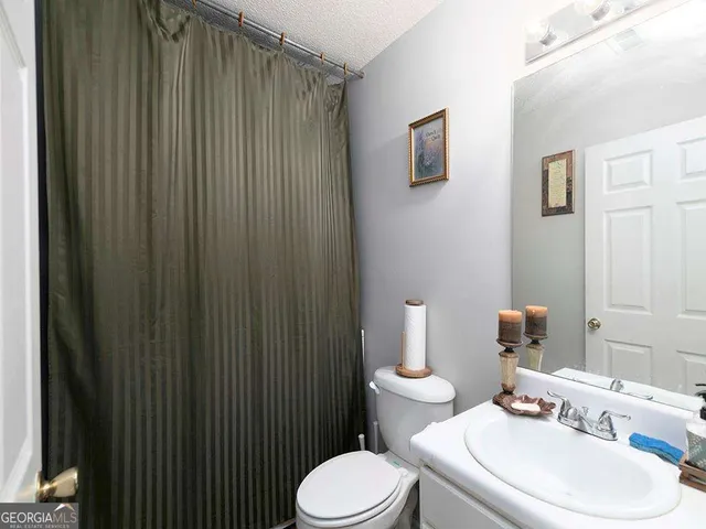 a white toilet sitting next to a bathroom sink