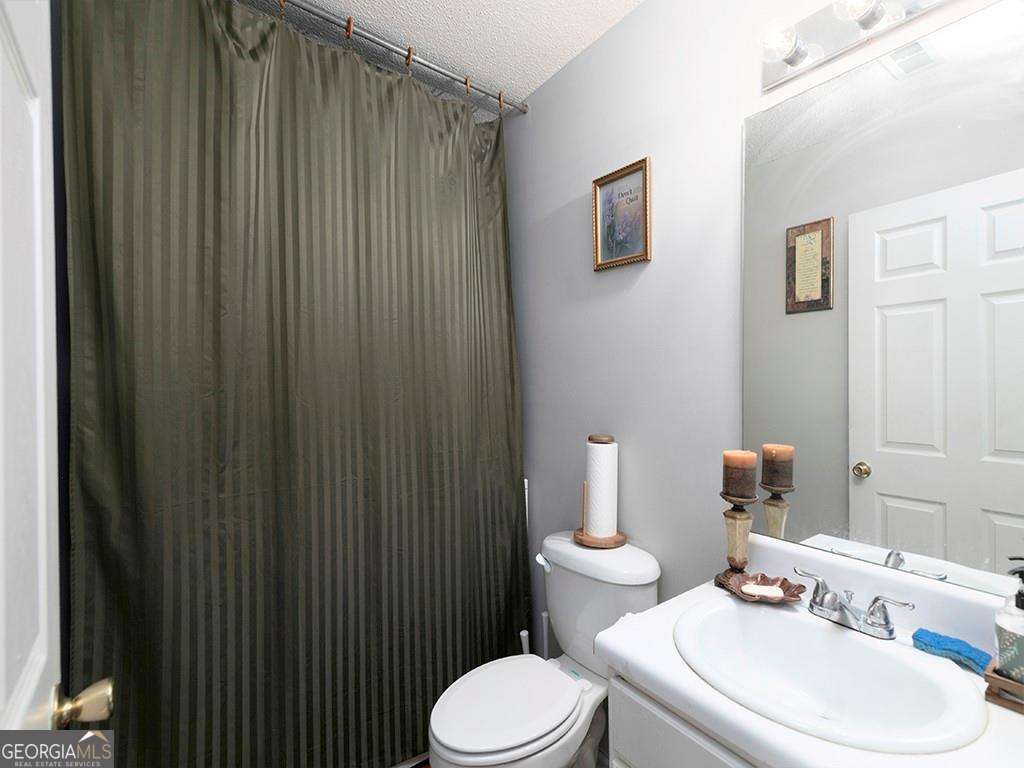 253 Gallant Court Southeast, Unit 17 Mableton, GA 30126 - Photo 19 of 20 a white toilet sitting next to a bathroom sink