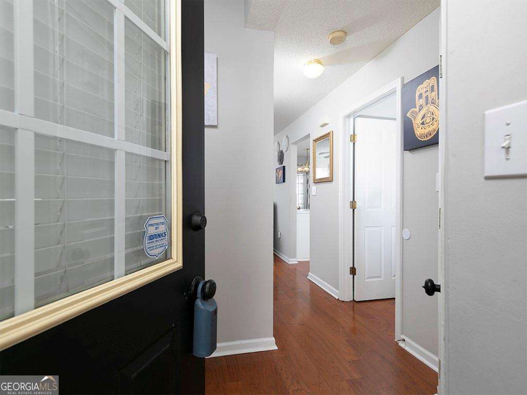 253 Gallant Court Southeast, Unit 17 Mableton, GA 30126 - Photo 3 of 20 a view of a hallway with wooden floor and windows
