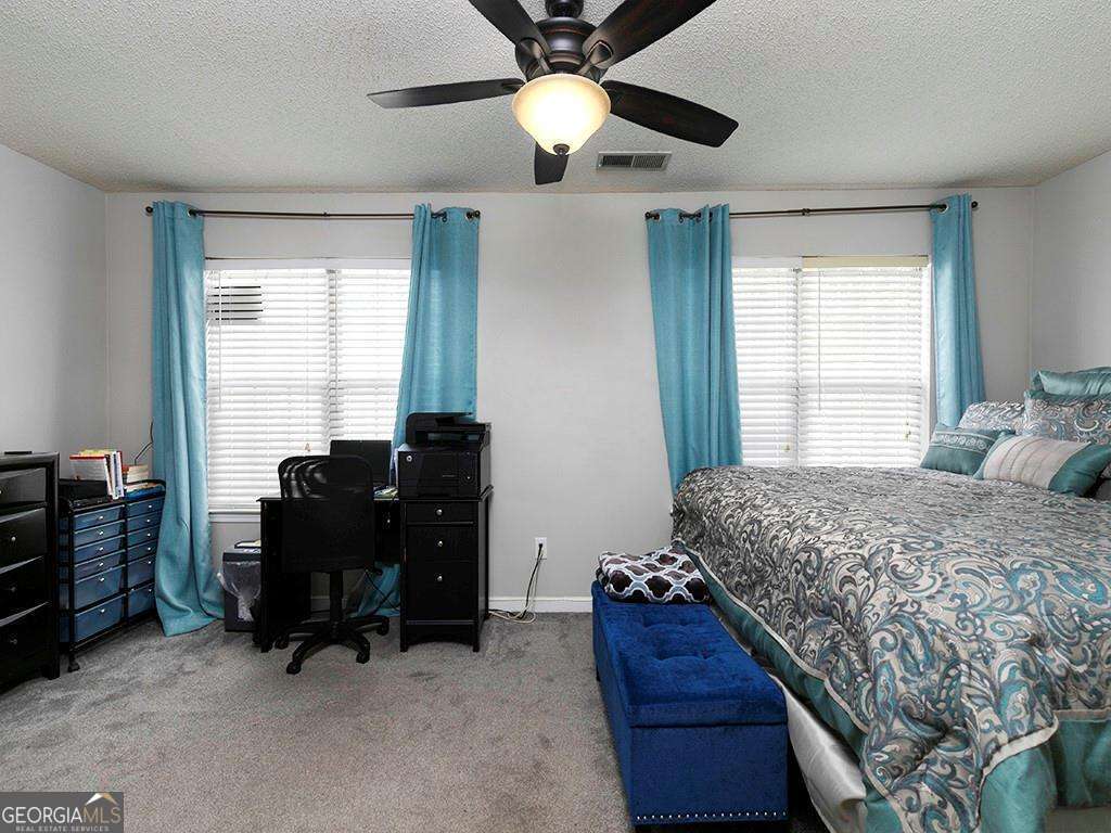 253 Gallant Court Southeast, Unit 17 Mableton, GA 30126 - Photo 8 of 20 a bedroom with a bed and a chandelier