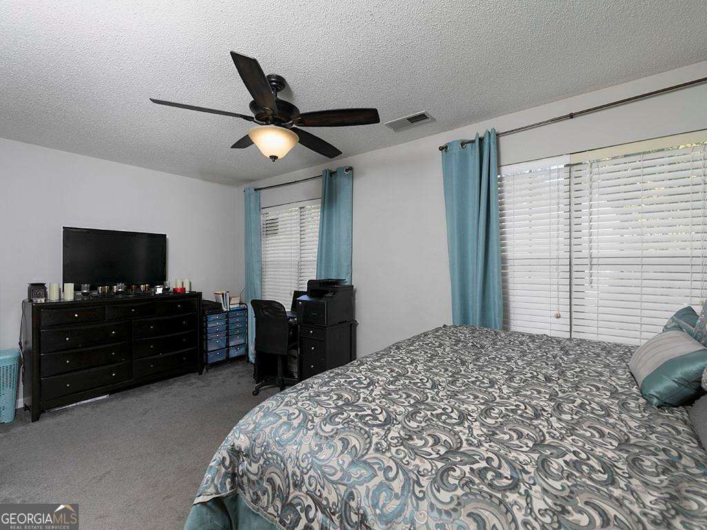 253 Gallant Court Southeast, Unit 17 Mableton, GA 30126 - Photo 9 of 20 a bedroom with a bed and a flat screen tv