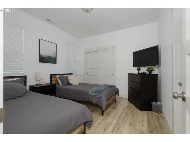a bedroom with furniture and a flat screen tv