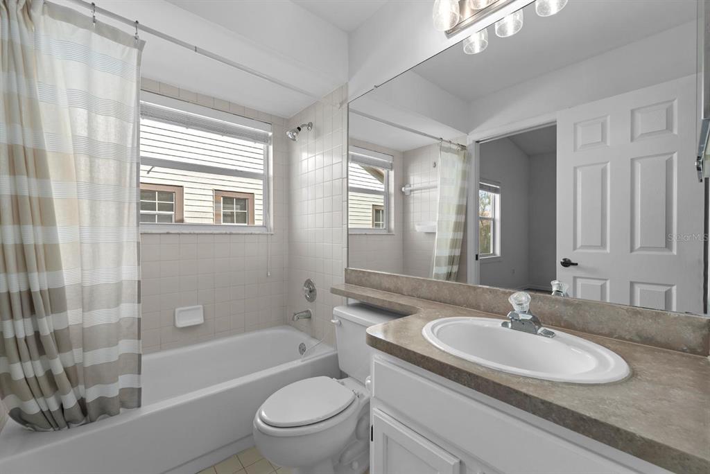 1227 Clays Trail Oldsmar, FL 34677 - Photo 22 of 37 a bathroom with a granite countertop sink toilet mirror and bathtub