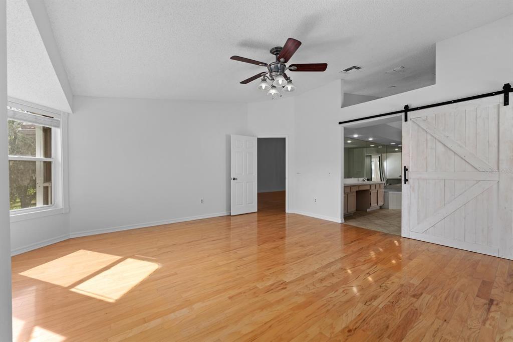 1227 Clays Trail Oldsmar, FL 34677 - Photo 23 of 37 wooden floor in an empty room with a window
