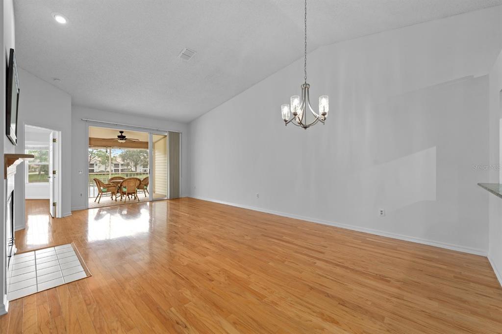 1227 Clays Trail Oldsmar, FL 34677 - Photo 9 of 37 a view of empty room with wooden floor and floor to ceiling window
