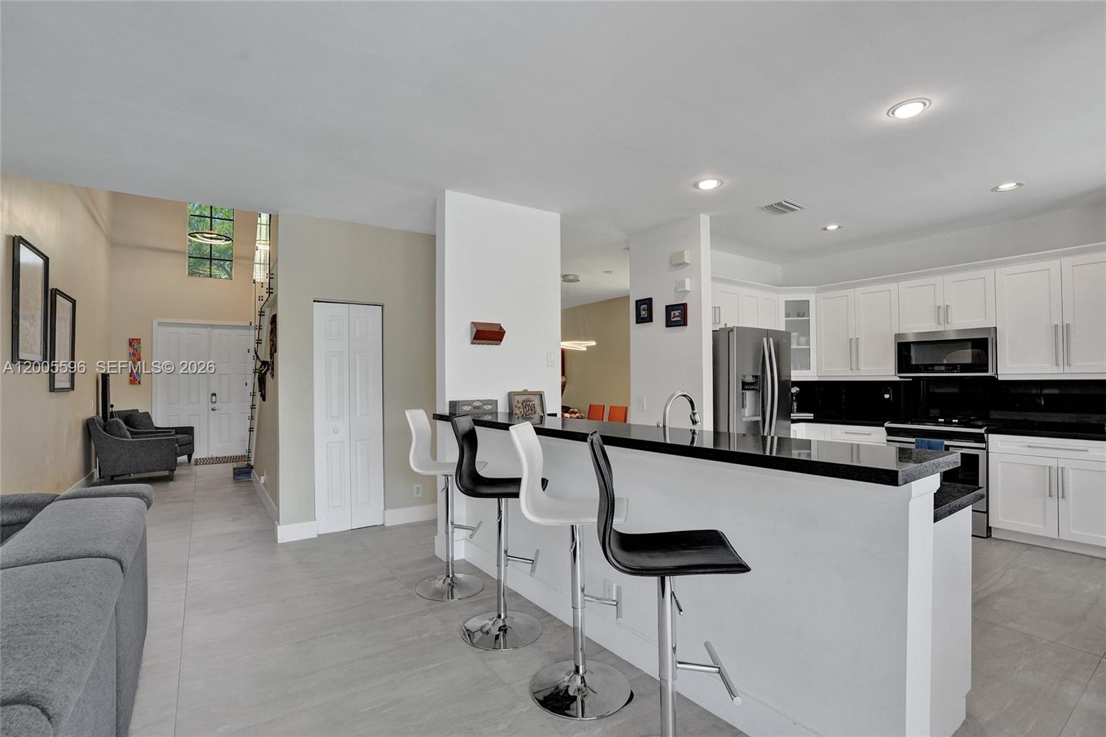 4281 Laurel Ridge Circle Weston, FL 33331 - Photo 24 of 80 a kitchen with stainless steel appliances kitchen island granite countertop a refrigerator and a stove top oven
