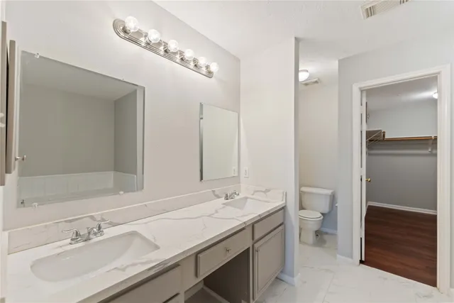 a bathroom with a sink double vanity and a mirror