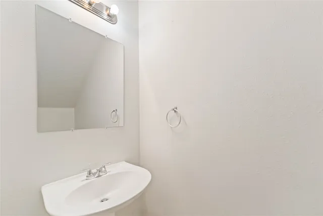 a bathroom with a sink and mirror