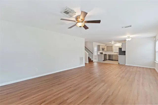 wooden floor in an empty room with a window