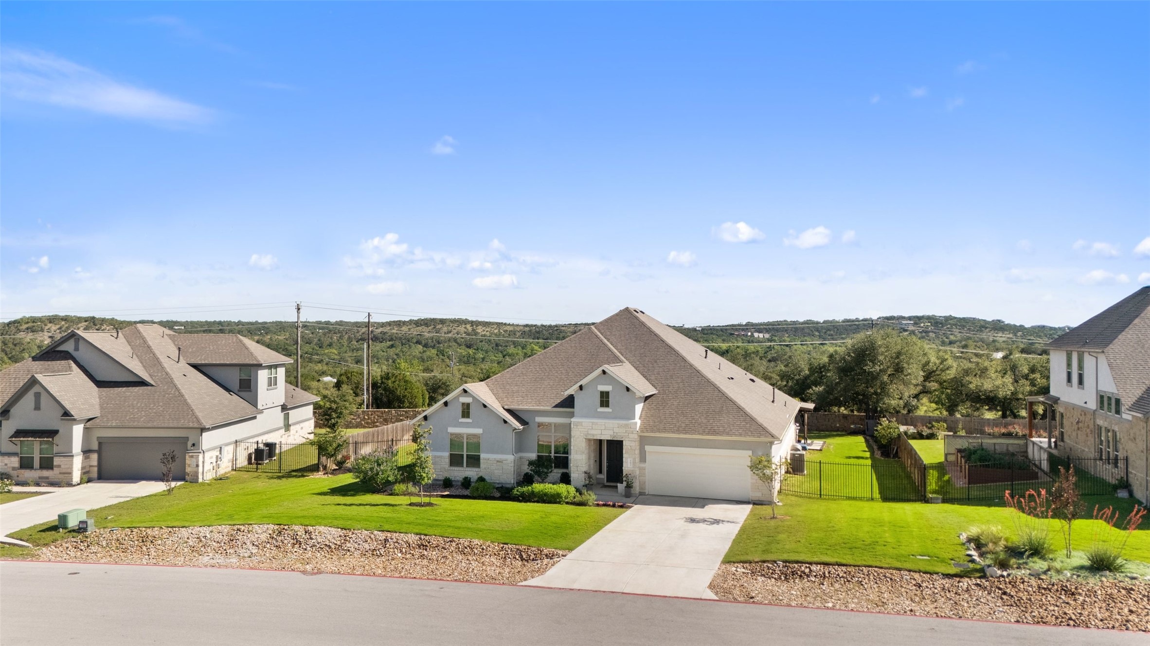162 Lunar Loop Austin, TX 78737 - Photo 35 of 40 front view of a house with a yard