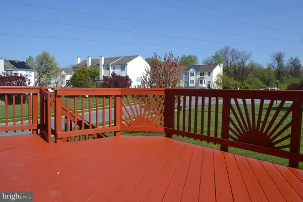 a view of balcony with wooden floor and fence