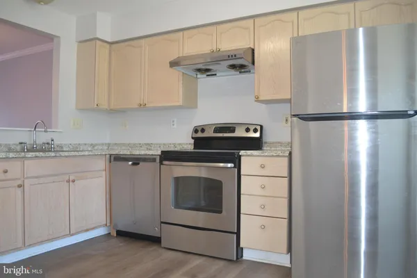 a kitchen with appliances cabinets and a counter top space