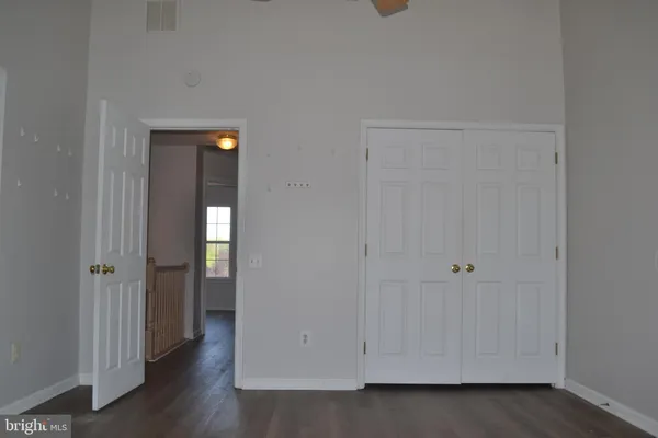 an empty room with wooden floor