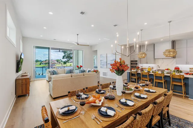 a living room with dining room and couches with kitchen view