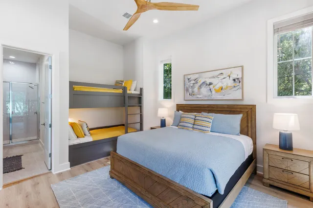 a bedroom with a bed and a painting on the wall