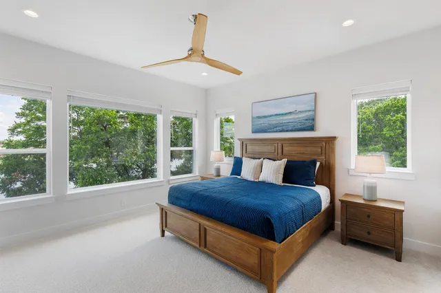 a bed sitting in a bedroom next to a window