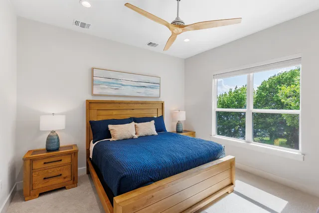 a bedroom with a large bed and a window