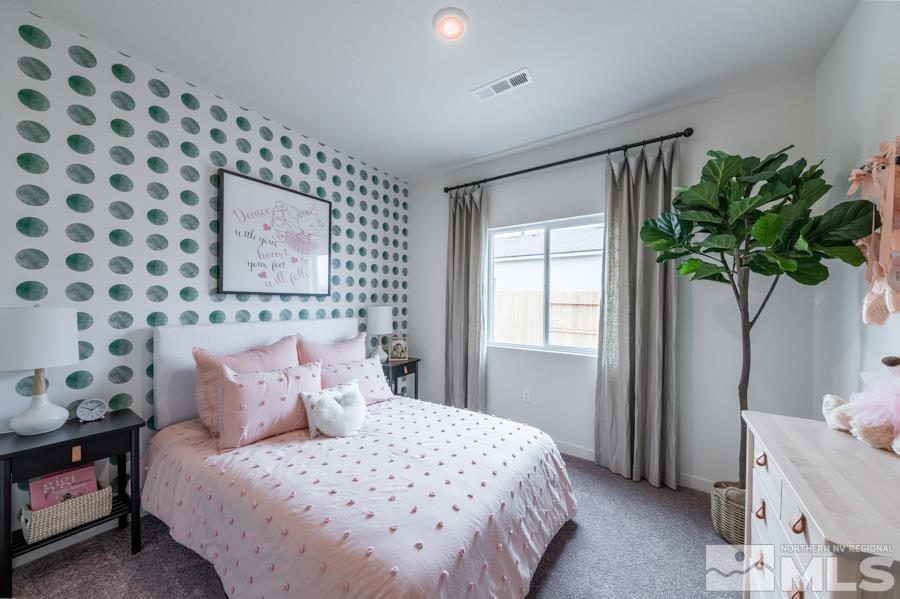 508 Russell Road, Unit LOT #96 Dayton, NV 89403 - Photo 14 of 17 a bedroom with a bed and a potted plant