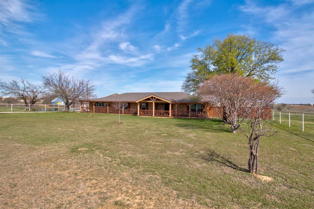 3884 Lois Road East Sanger, TX 76266 - Photo 4 of 40 a front view of a house with a garden
