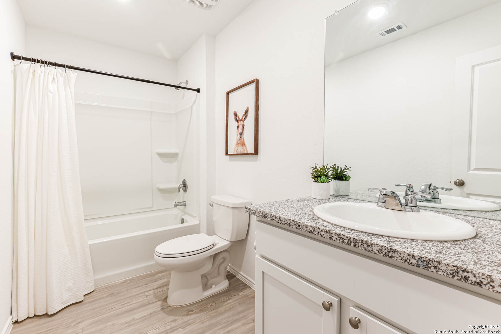 5935 Texas Seguin, TX 78155 - Photo 17 of 20 a bathroom with a granite countertop sink toilet a large mirror a shower and a bathtub